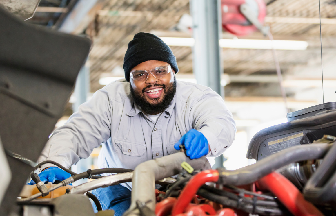 African-American mechanic repairing semi-truck