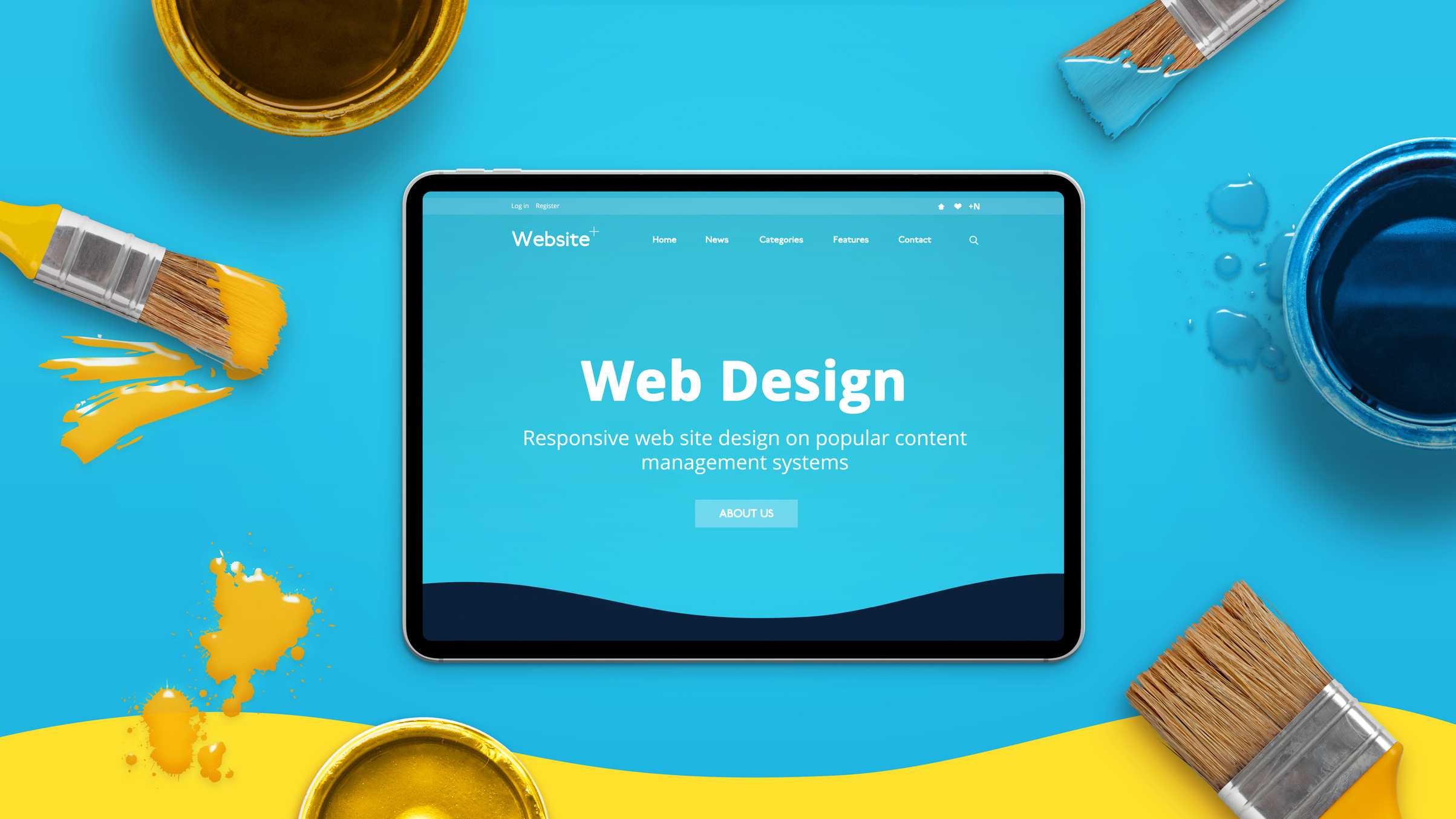 Web design concept with modern flat design theme on a thin tablet surrounded by color brushes and boxes. Top view, flat lay.
