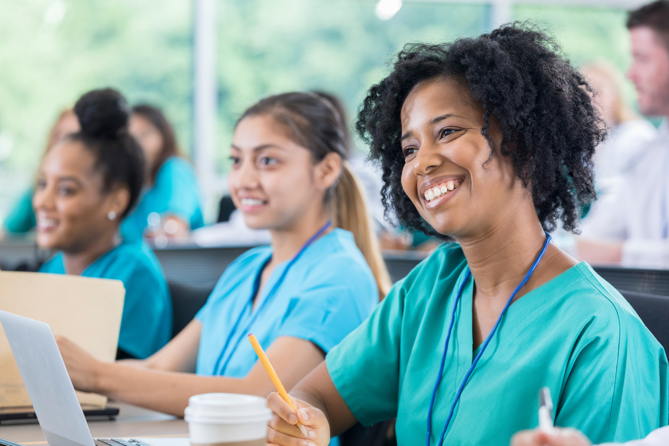 Smiling African American nurse attends continuing education class